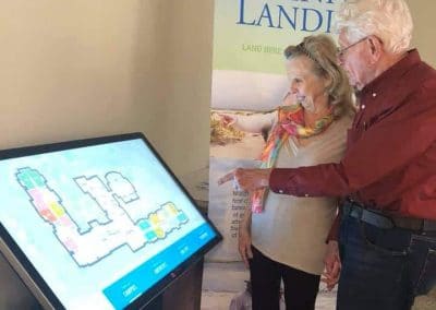 Future residents use the virtual tour board to check out the Trinity Landing residences.
